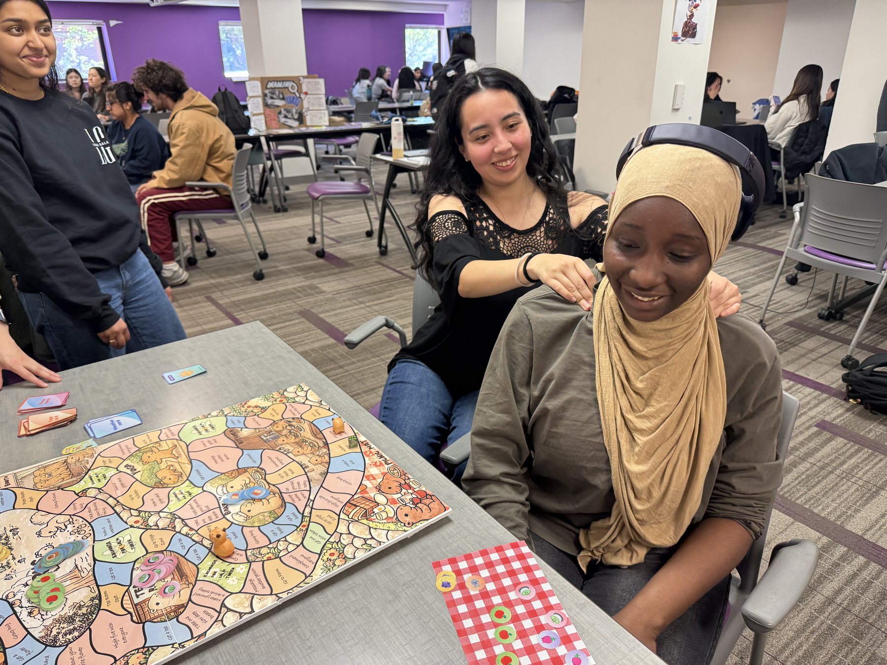 Participants completing a gentle social activity beside the final game board