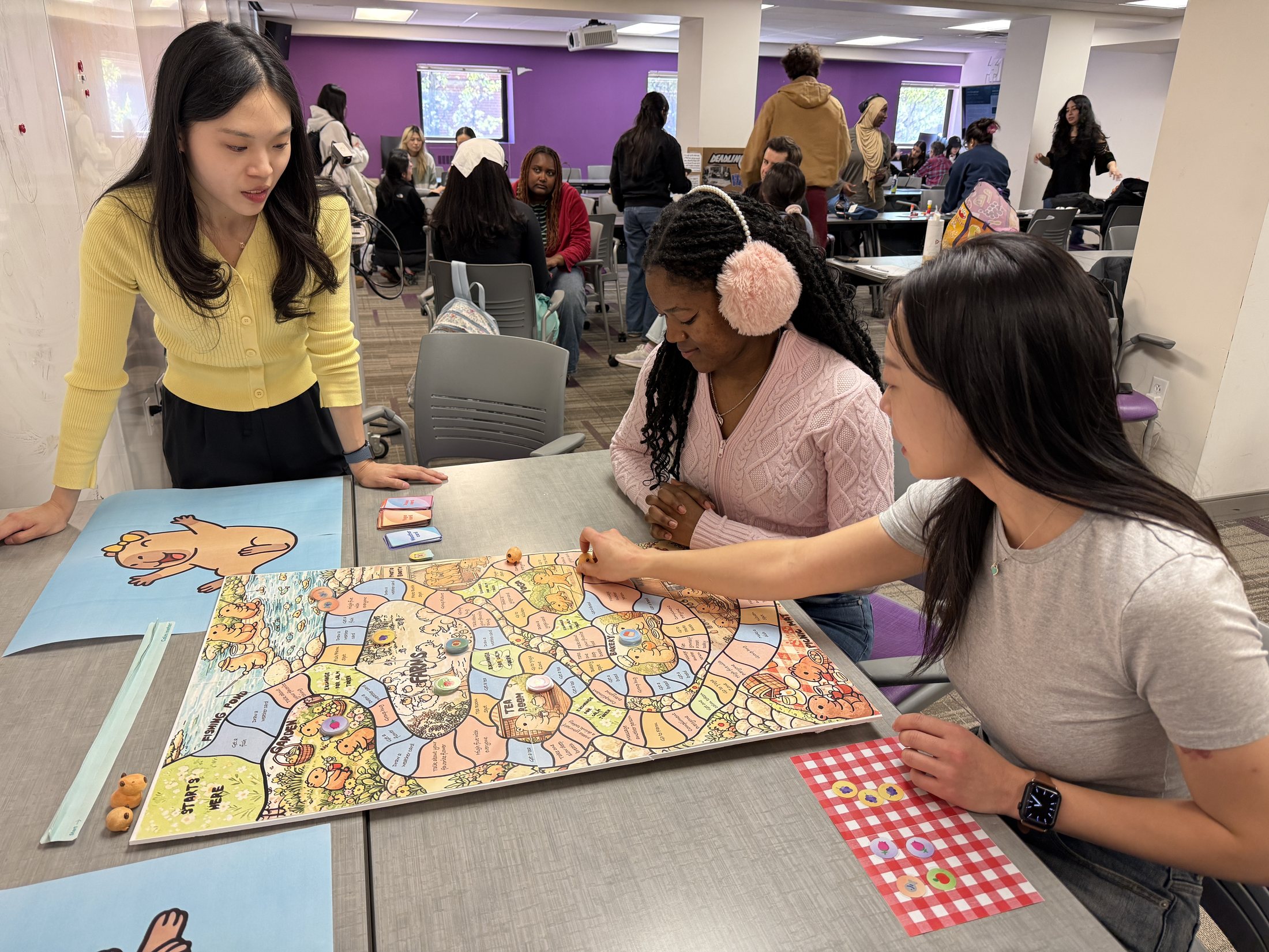 Participants playing the final Capybara Land board game together
