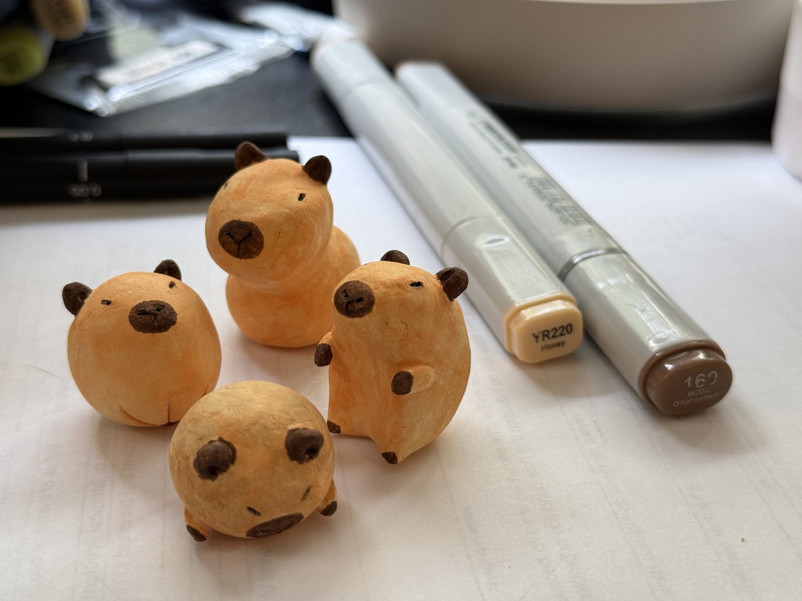 Four handmade capybara game pieces