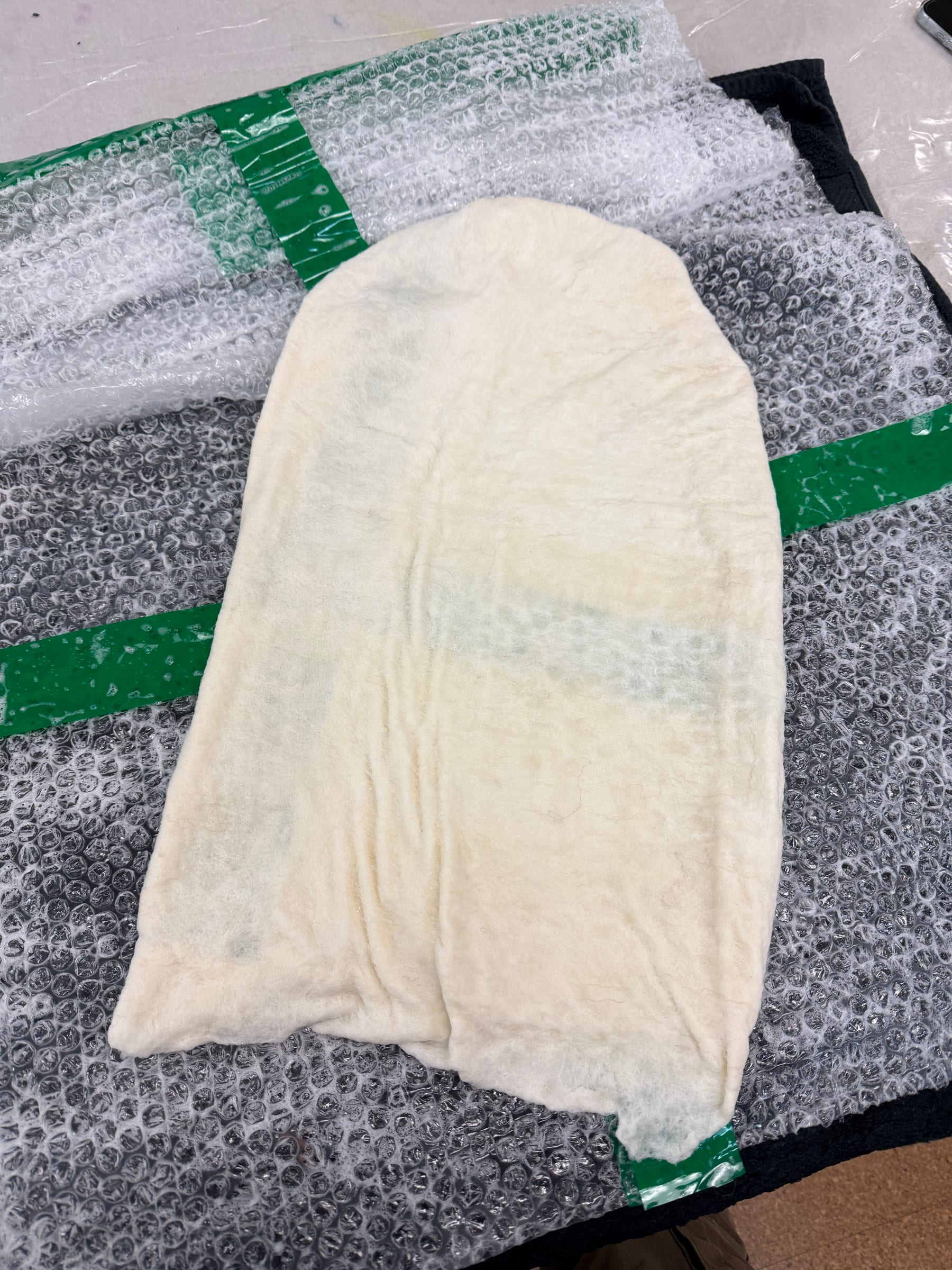 The wet-felted wool being worked around and removed from the resist